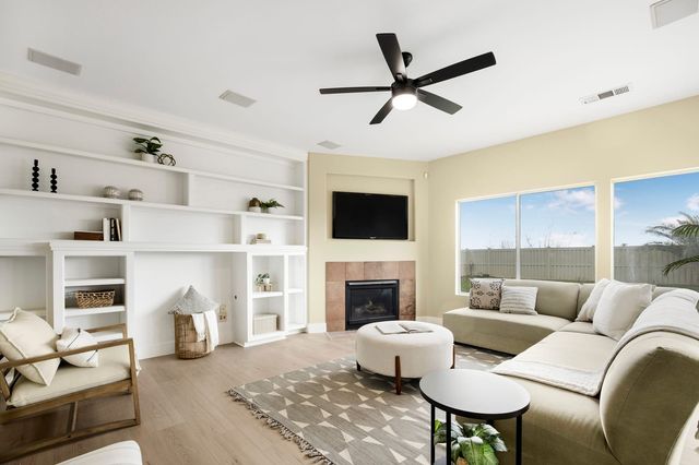 Family room with built-in shelves, a corner fireplace and a sectional sofa